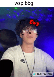 a man with curly hair is wearing glasses and a hello kitty face mask .