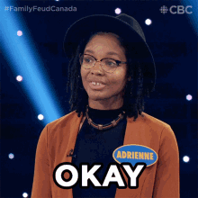 a woman with glasses and a name tag that says adrienne on it