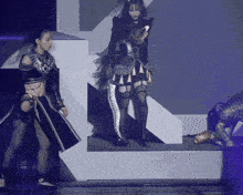 a woman holding a sword is standing next to another woman