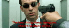a man in a suit and tie is pointing a gun at another man with the words " the best thing about being me "