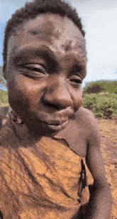 a close up of a man 's face with a leaf on his shoulder