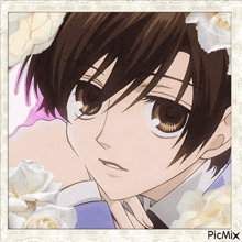 a close up of a boy 's face with white roses in the background .
