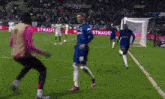 soccer players on a field with the word strauss on the side