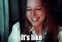 a woman is smiling and saying it 's like .