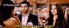 a man and a woman are talking to each other in a bar .