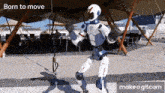 a robot with the words born to move on the bottom