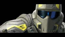 a close up of a person wearing a helmet with the letter t on the front