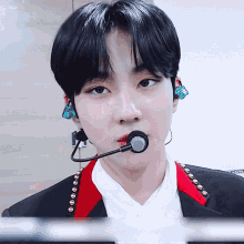 a close up of a person wearing a microphone and earbuds