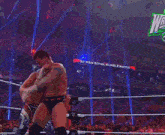 two men are wrestling in a ring with a sign that says 30 man royal rumble match in the background