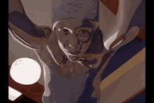 a statue of a man with horns is hanging from the ceiling of a building .