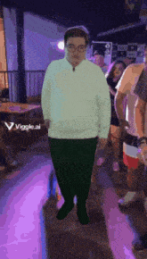 a man in a white sweater and green pants is standing in front of a group of people with a purple background