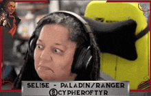 a woman wearing headphones is sitting in front of a sign that says selise paladin ranger