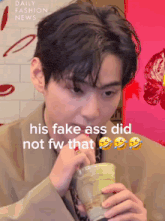 a man drinking from a cup that says his fake ass did not fw that on the bottom