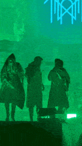 a blurry photo of a person standing in front of a green background