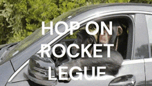 a chimpanzee is driving a car with the words hop on rocket legue written above it
