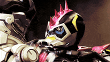 a robot with spikes on it 's head is being held by another robot