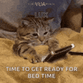 a cat is laying on a bed looking at a cell phone with the words lux time to get ready for bed time written below it