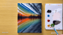 a painting of a sunset is being painted by joony art