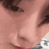 a close up of a person 's face with their eyes closed .