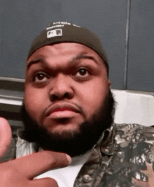a man with a beard is wearing a hat that says atlanta on it