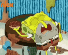 spongebob squarepants is sitting at a table with a pizza and a bottle of water .