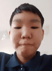 a close up of a person 's face with a serious look on his face