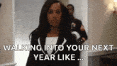 a woman in a suit is walking into her next year like a soldier .