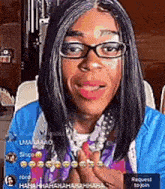 a woman wearing glasses and a blue jacket is laughing .