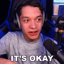 a young man wearing headphones says it 's okay