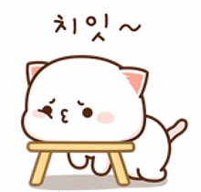 a cartoon cat is sitting on a small wooden stool with korean writing on it .