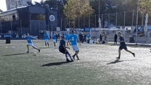 a group of people are playing a game of soccer on a field .