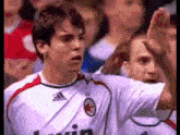 a soccer player wearing a white shirt with the word bwin on it