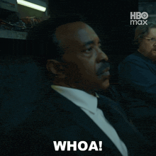 a man in a suit says whoa in front of a hbo max logo