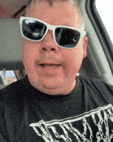 a man wearing sunglasses and a black shirt that says ' nightmare '