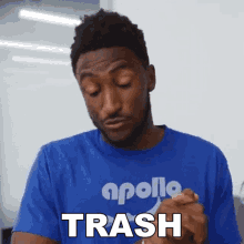 a man wearing an apollo shirt says trash