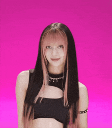 a woman with long black hair and pink streaks is wearing a bracelet that says idol