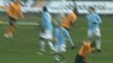 a blurry picture of soccer players on a field with a sign in the background that says ' soccer '