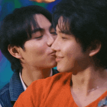 two young men are kissing each other on the cheeks