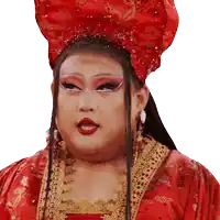 a woman wearing a red dress and a red hat looks at the camera
