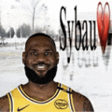 a man with a beard is wearing a yellow nike jersey and smiling .