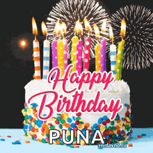a birthday cake with candles and fireworks behind it and the words `` happy birthday puna '' .