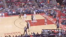 a basketball game is being played in front of a toyota advertisement