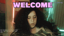 a girl with curly hair is standing in front of a welcome sign