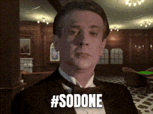 a man in a tuxedo has the hashtag #sodone written on his face