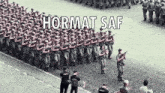 a group of soldiers marching down a street with hormat saf written on the bottom
