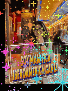 a woman sits at a table with a sign that says iberoamerica canta