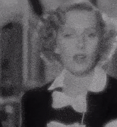 a woman wearing a bow tie and a black jacket