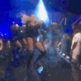 a blurry picture of a group of people dancing on a stage