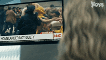 a breaking news report about homelander not guilty is displayed on a television screen