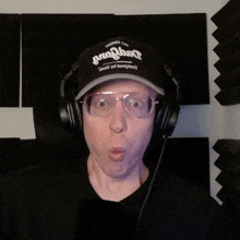 a man wearing headphones and a hat that says ' penguin '